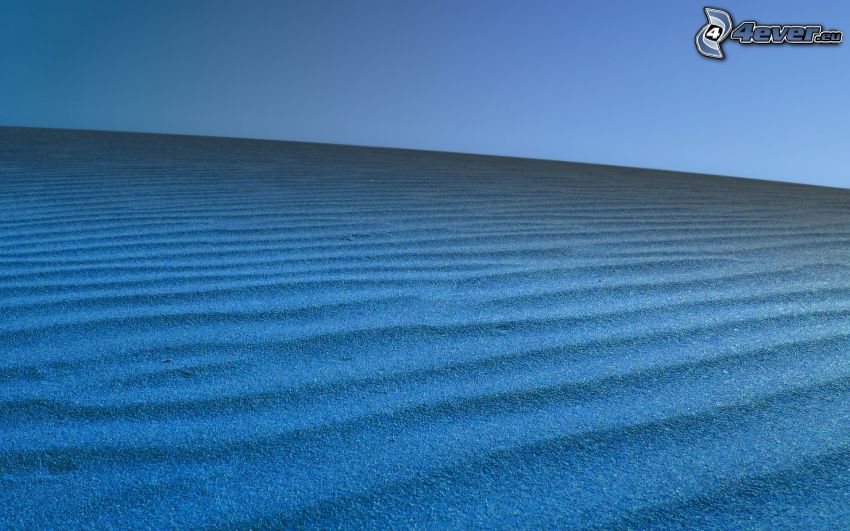 Sand, blauer Hintergrund