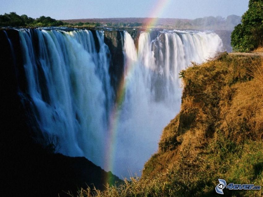 enormt vattenfall, regnbåge, savann