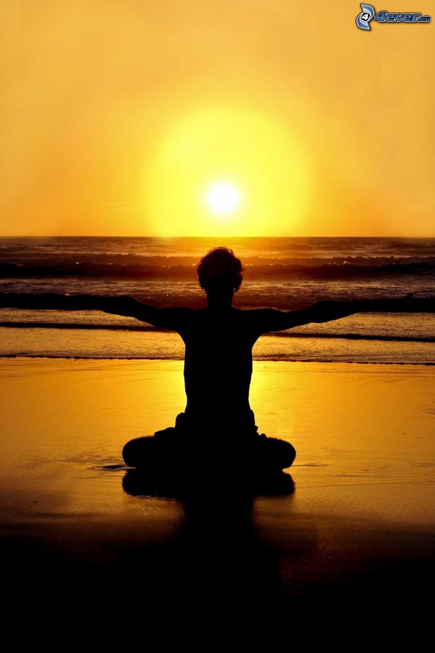 yoga, benen i kors, solnedgång över hav, gul himmel