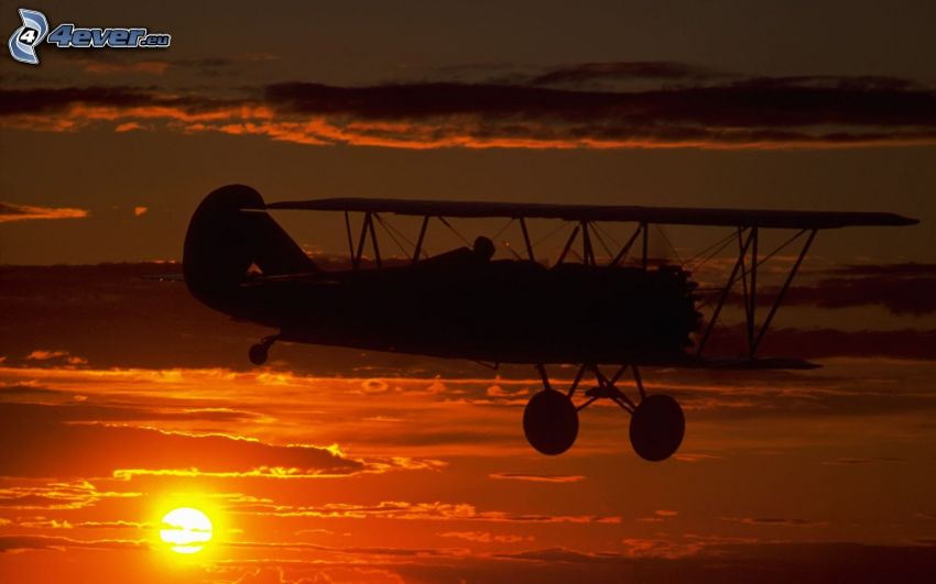 biplano, silueta de la aeronave, puesta del sol
