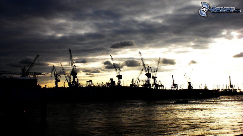puesta de sol en el puerto, grúa, siluetas, nubes