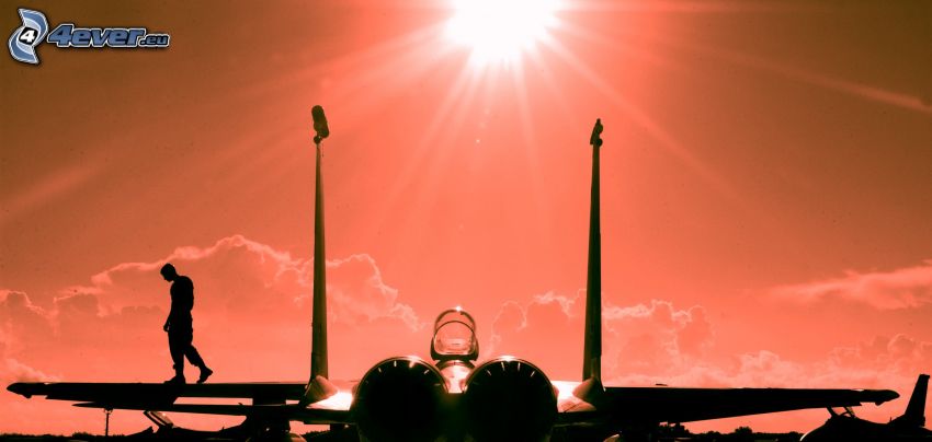 silhouette de l'avion de chasse, silhouette d'un homme, soleil