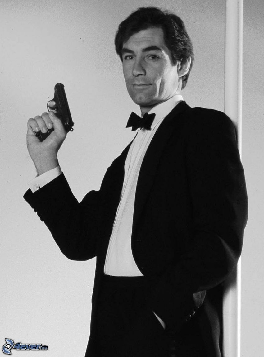 Timothy Dalton, homme avec un fusil, homme en costume, quand elle est jeune, photo noir et blanc