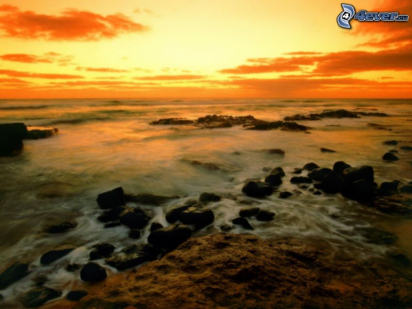 Hawaii, roches dans la mer, coucher du soleil orange, après le coucher du soleil
