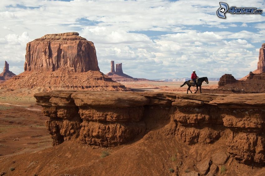 Monument Valley, sivatagi sziklák, cowboy, barna ló