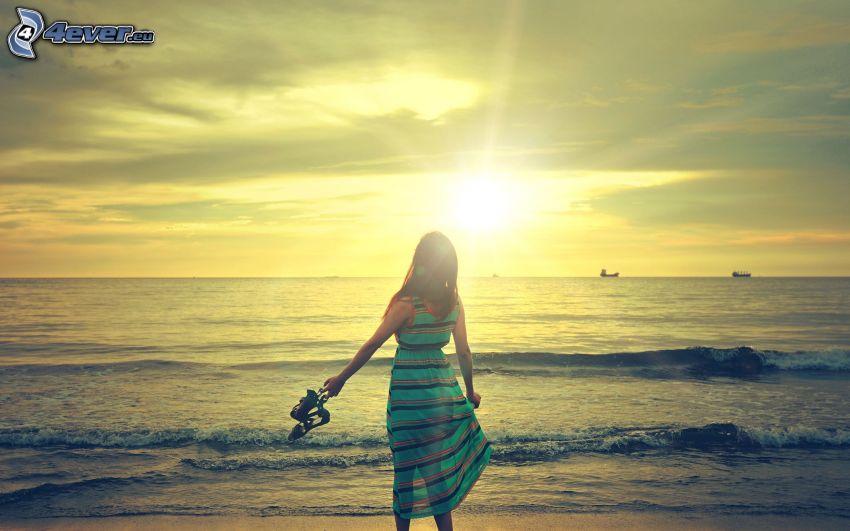 dievča pri mori, západ slnka nad morom