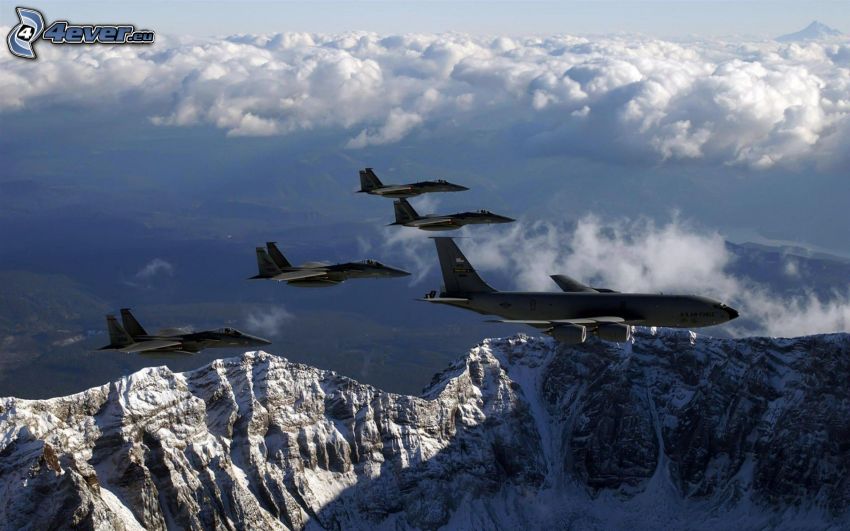 Fleet of F-15 Eagle, snowy mountains