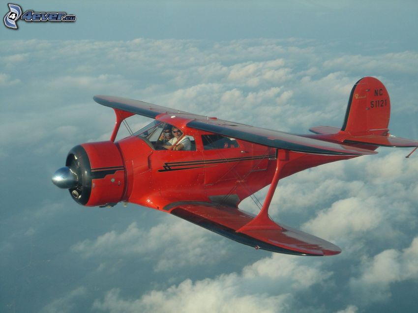 biplane, over the clouds