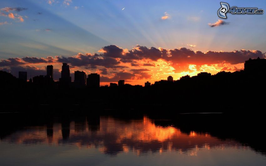 Minneapolis, silhouette of the city, sunbeams behind clouds