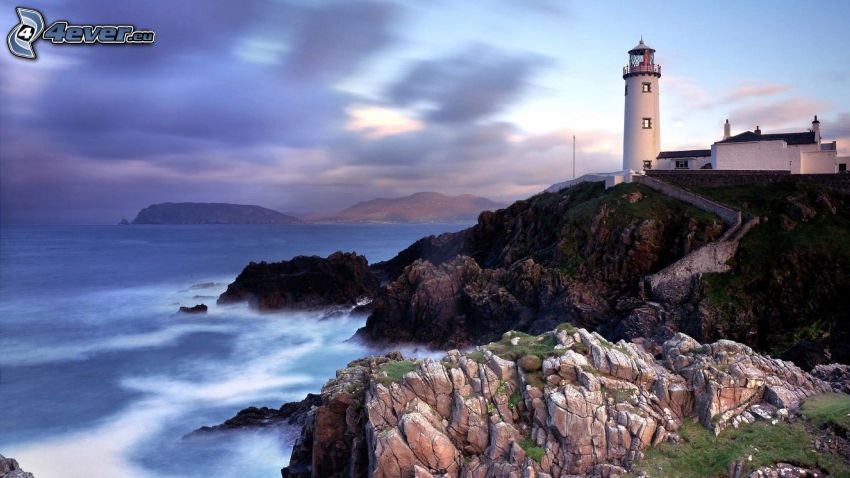 lighthouse on a cliff, rocky coastline, sea