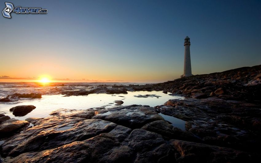 lighthouse at sunset, rocky coastline