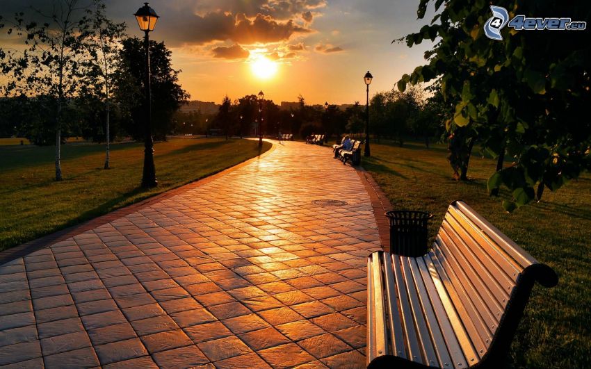 park at sunset, sidewalk, benches, lamps