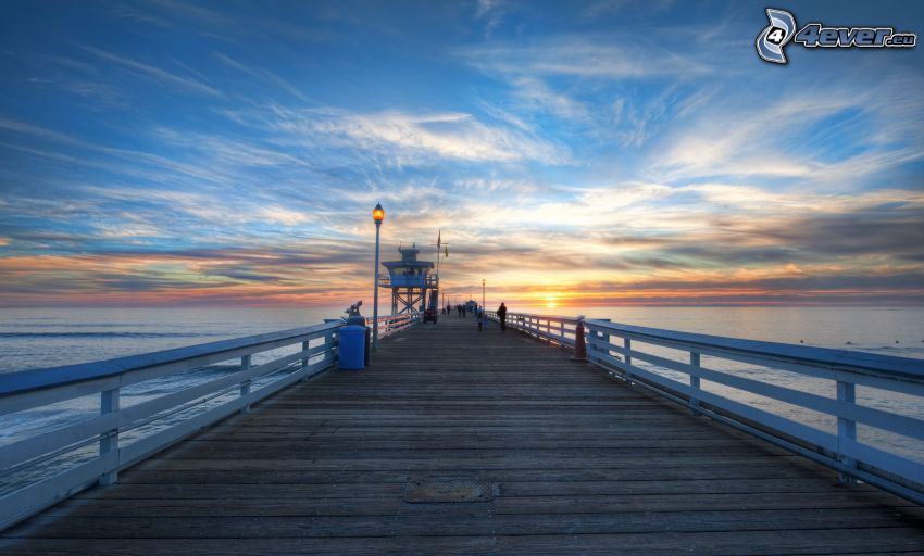 wooden pier, sunset behind the sea, HDR