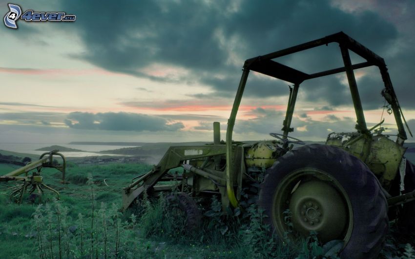 Old abandoned tractor, wreck, clouds