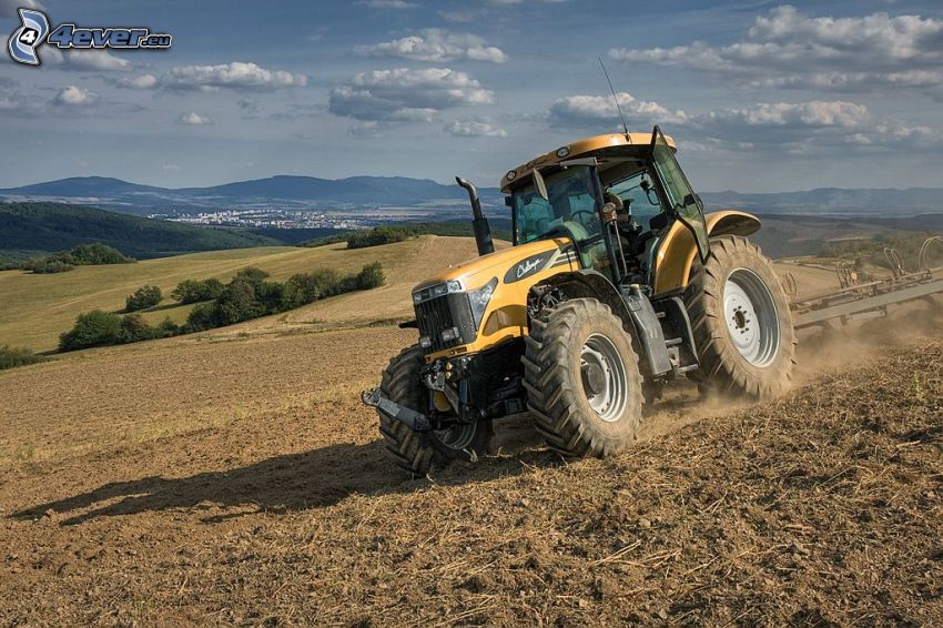 tractor on field, dust, hills, plowing