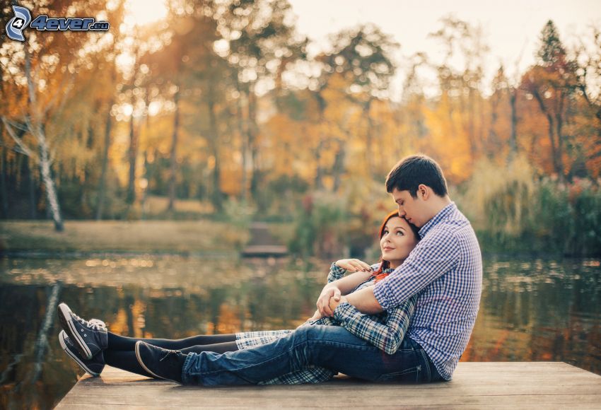 couple at the lake, autumn trees, pier