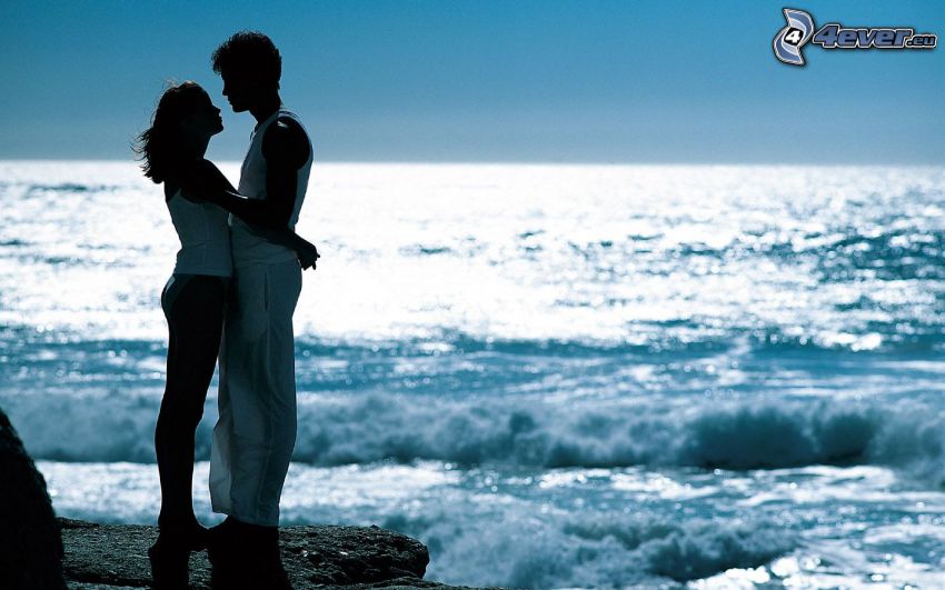couple by the sea, gentle embrace, waves on the shore