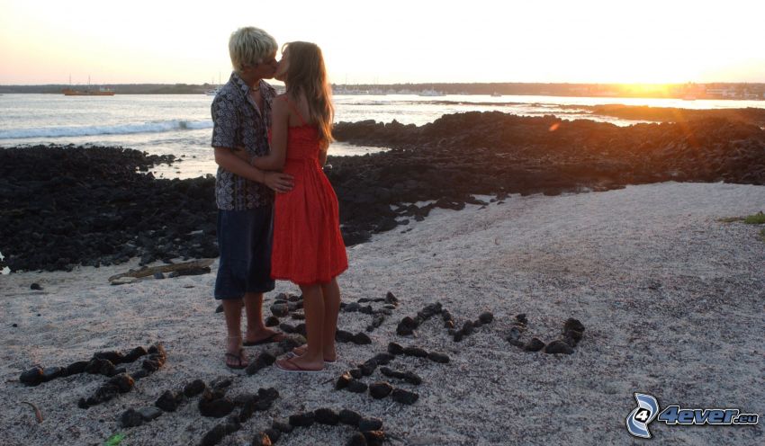 couple by the sea, kiss, sunset behind the sea