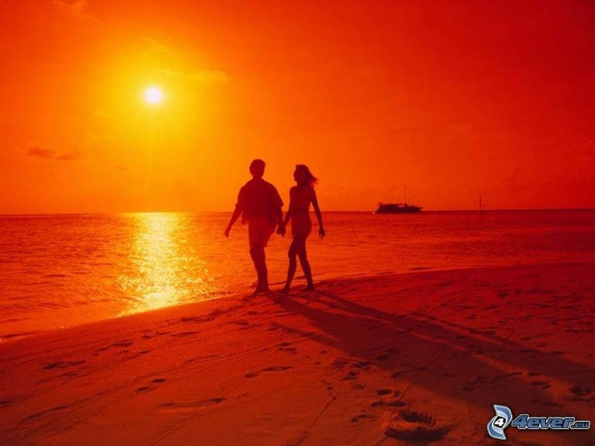 couple by the sea, orange sunset over the sea