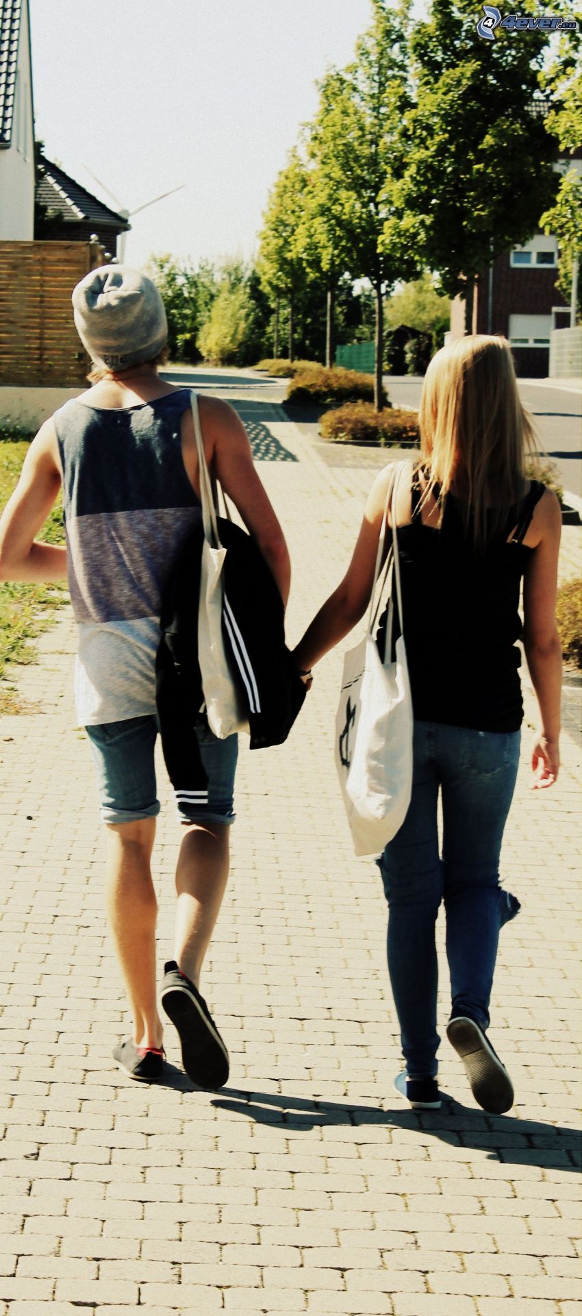 couple in town, walking, holding hands, sidewalk, street