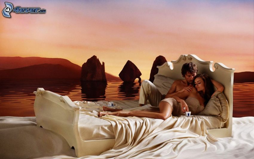 couple on bed, sea, rocks