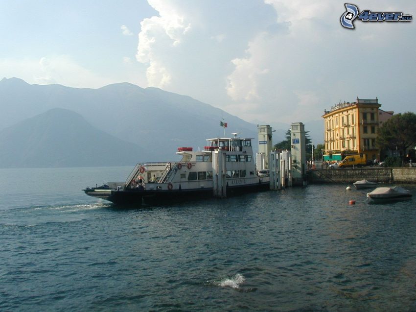 port on lake, tourist boat, mountains