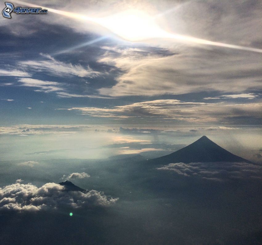 Mount Mayon, Philippines, over the clouds, sun
