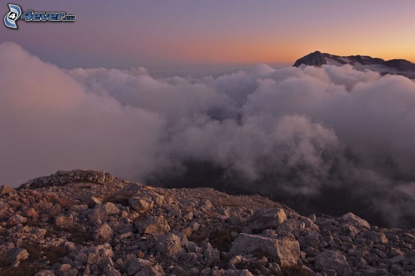 over the clouds, high mountains, sunset, rocks