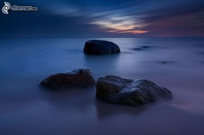 rocks in the sea, after sunset
