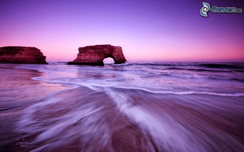rocky gate on sea, beach, purple sky