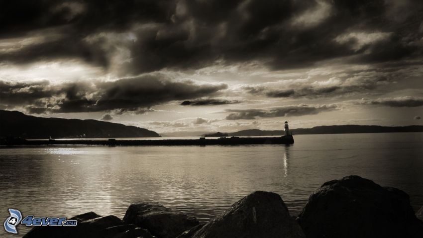 sea, lighthouse, pier, dark clouds, black and white photo