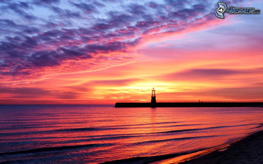 sunset at sea, pink sky, pier with a lighthouse