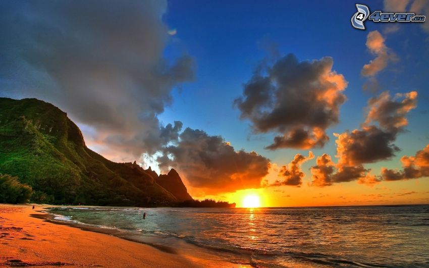 sunset behind the sea, clouds, sandy beach