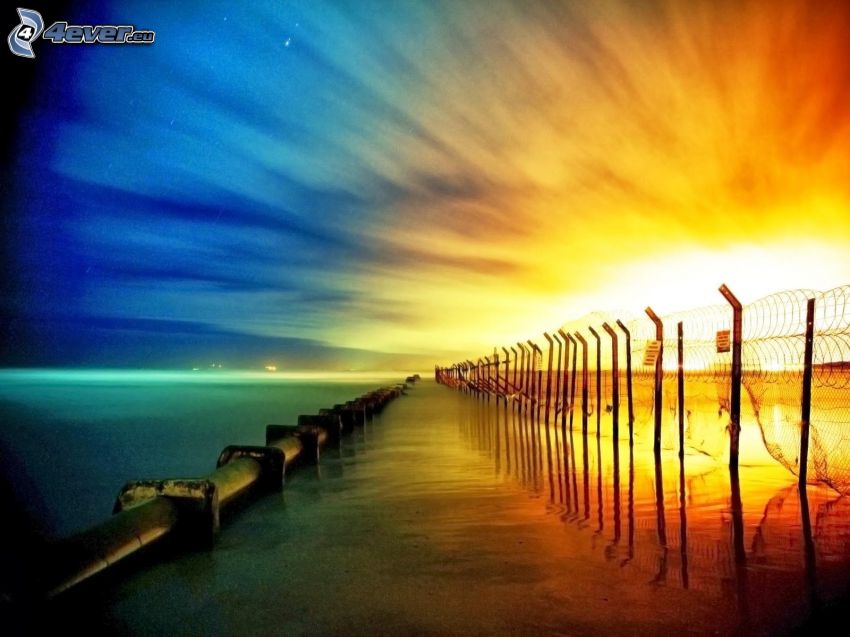 sunset behind the sea, fence, open sea