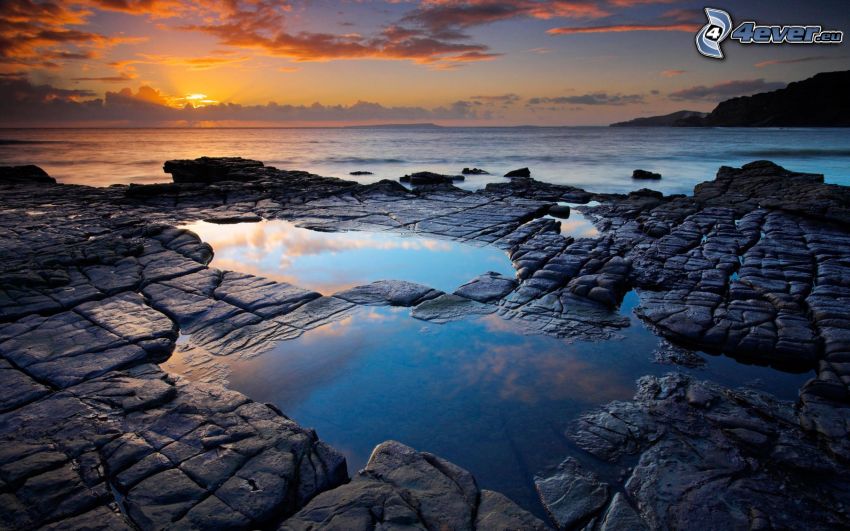 sunset behind the sea, rocks