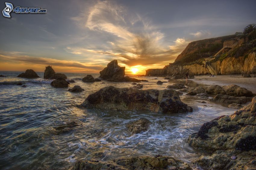 sunset behind the sea, rocky coastline, HDR