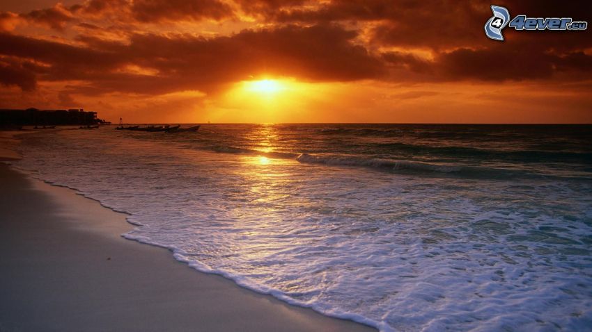 sunset behind the sea, sandy beach