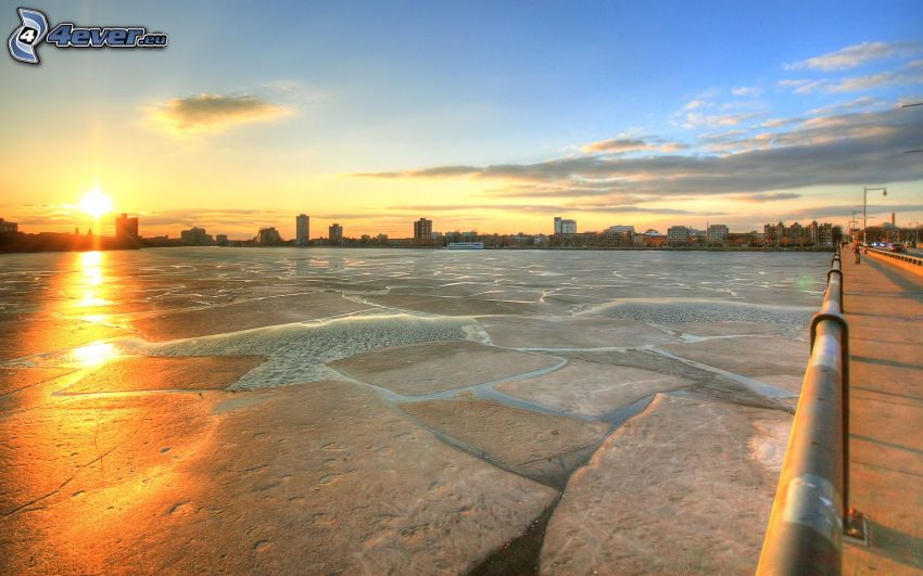 frozen river at sunset, bridge, city