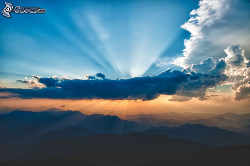 sun behind the clouds, sunbeams, mountains
