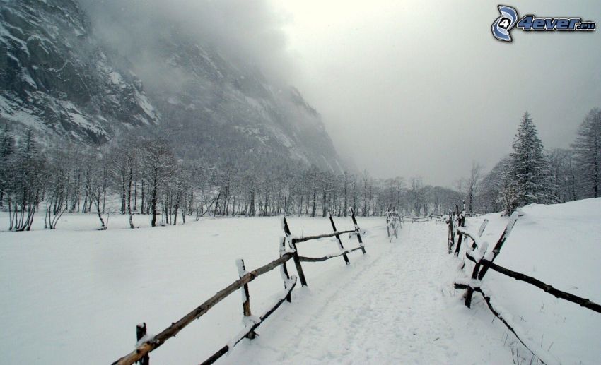 snowy landscape, railing, rocky hill