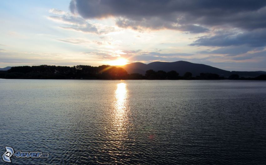 sunset over the lake, mountain, reflection of the sun