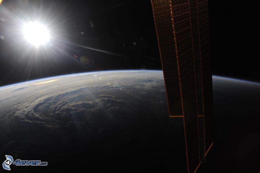 ISS over Earth, sun