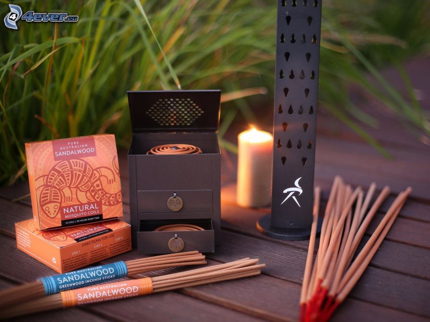 incense sticks, candle, blades of grass