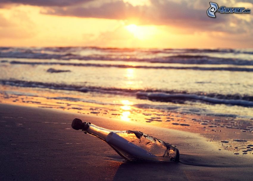 message in bottle, beach, sunset behind the sea