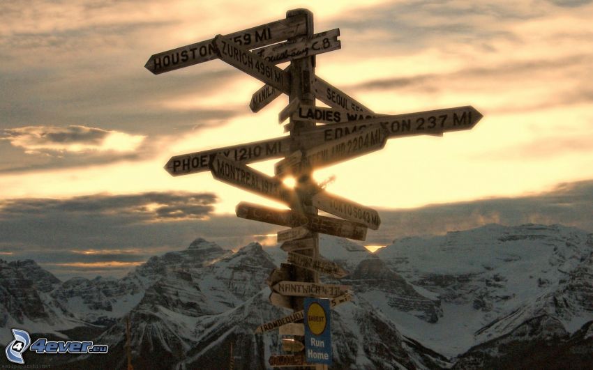 sign, snowy mountains, sunset in the mountains