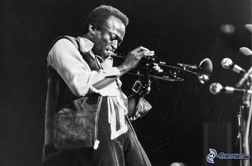 Miles Davis, trumpet playing, black and white photo