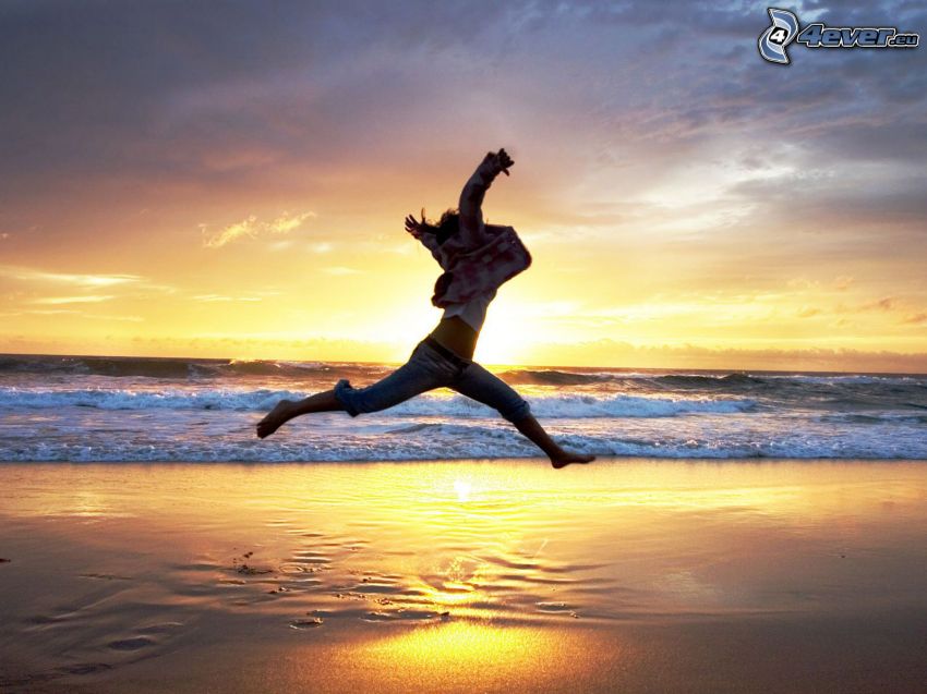 jump, sunset behind the sea, sandy beach