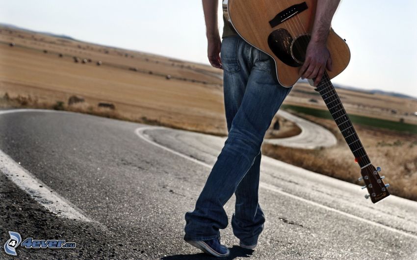 man with guitar, road
