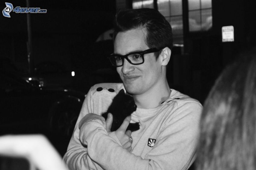 Brendon Urie, man with glasses, black kitten, black and white photo