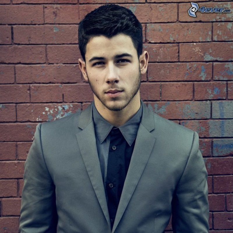 Nick Jonas, brick wall